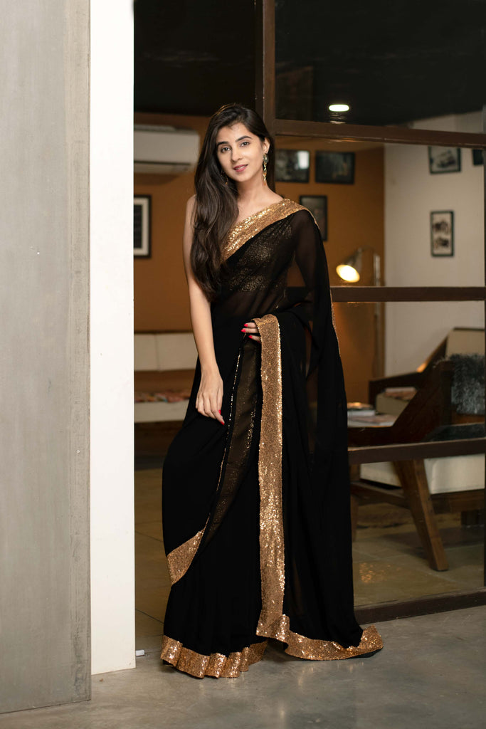 Photo of Elegant black saree with large border and full sleeves high neck  blouse